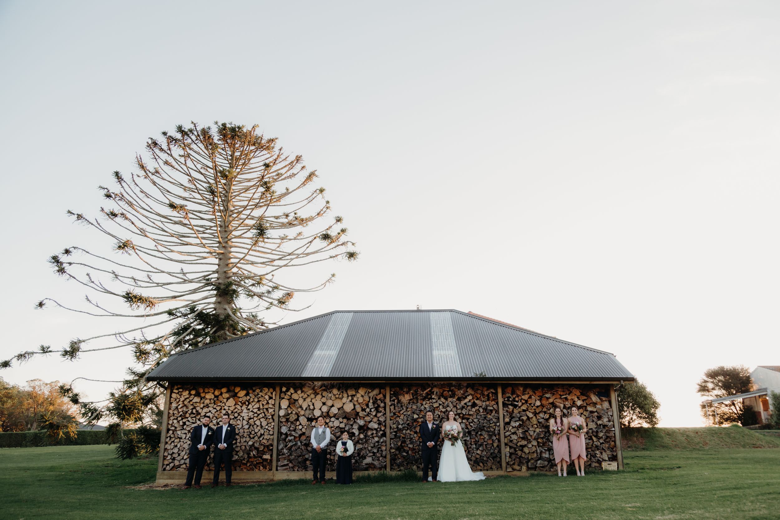 bridal party photo infront of a woodshed on a farm lavalla wedding venue