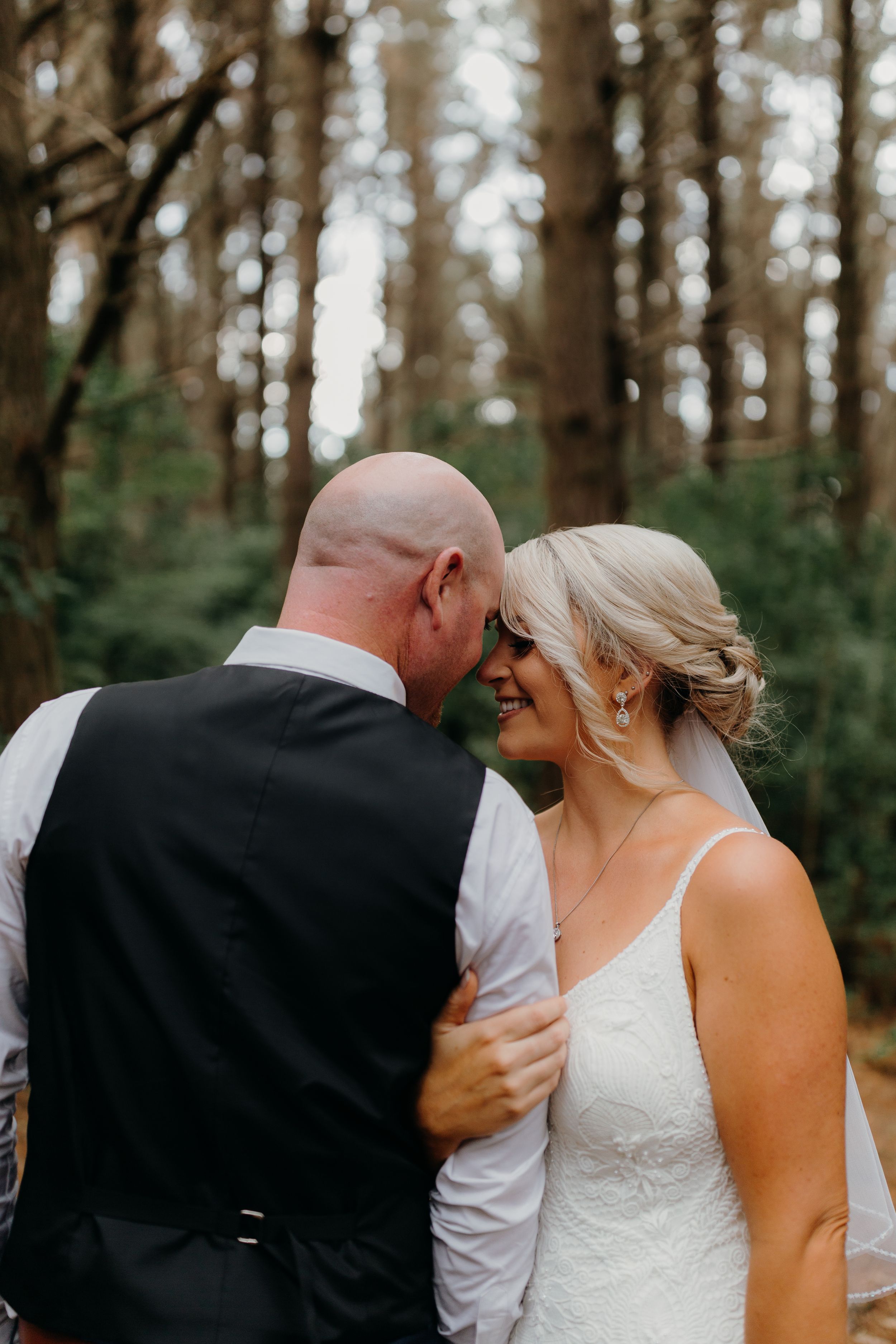 redwoods forest wedding couple bride hugging grooms arm