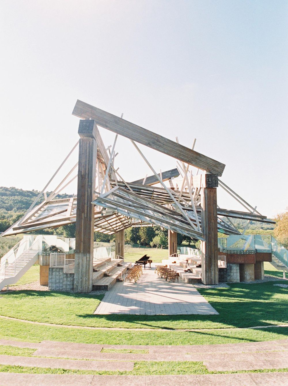 Outdoor wedding ceremony at Frank O. Gehry's Music Pavilion in Château La Coste, Provence - wooden structure.