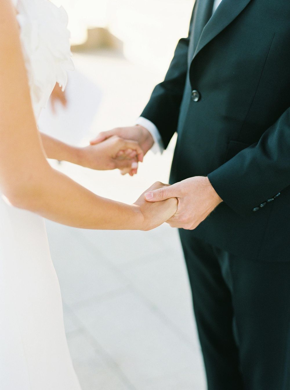 A beautiful couple holding hands and exchanging vows.