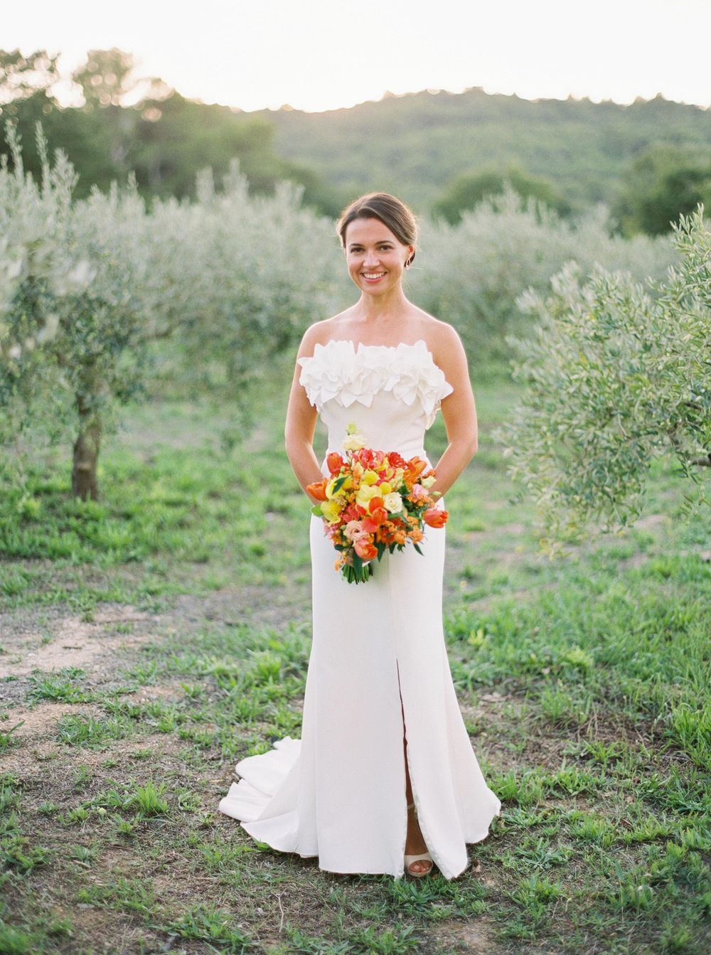 Proven wedding photographer Stepan Vrzala captures a stunning moment of a bride posing amidst olive trees in Provence.
