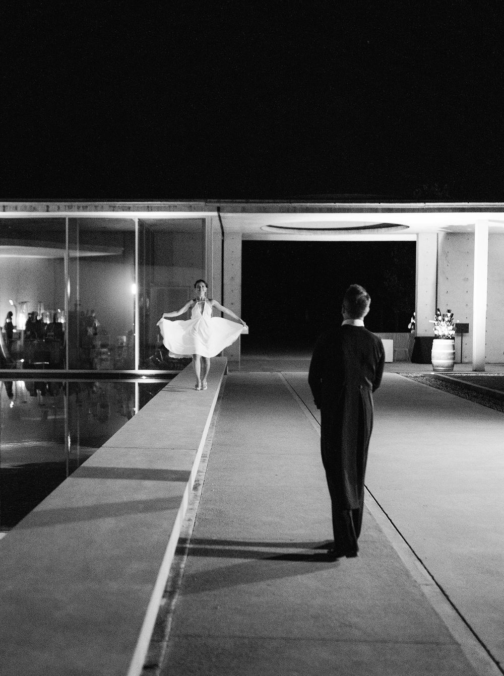 A romantic moment captured as a groom and bride stand on a walkway, enjoying their first dance at Château La Coste.