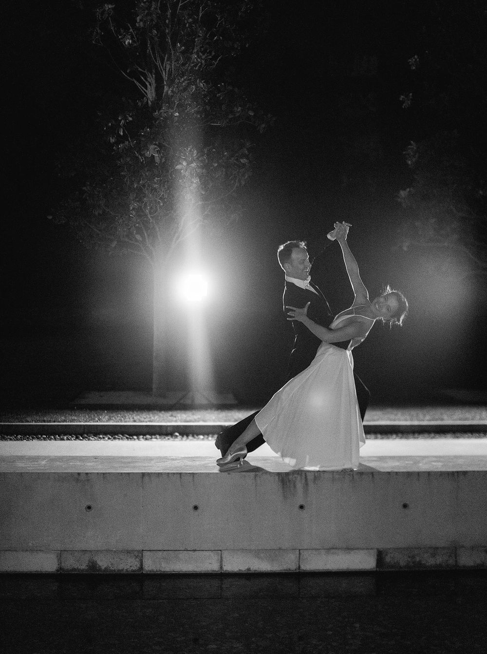A newlyweds gracefully dancing under the night sky at Château La Coste, Provence.