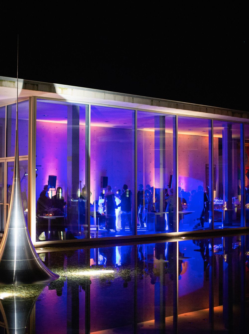 An elegant venue, Château La Coste, showcasing a pool and a stunning window, setting the scene for a wedding party.
