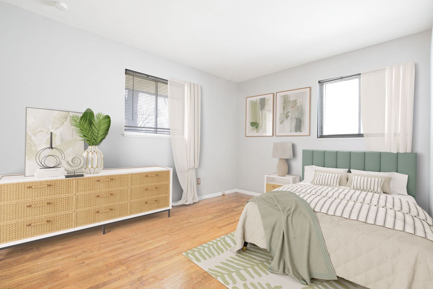 Modern bedroom with natural wood dresser, green accents, and hardwood flooring.