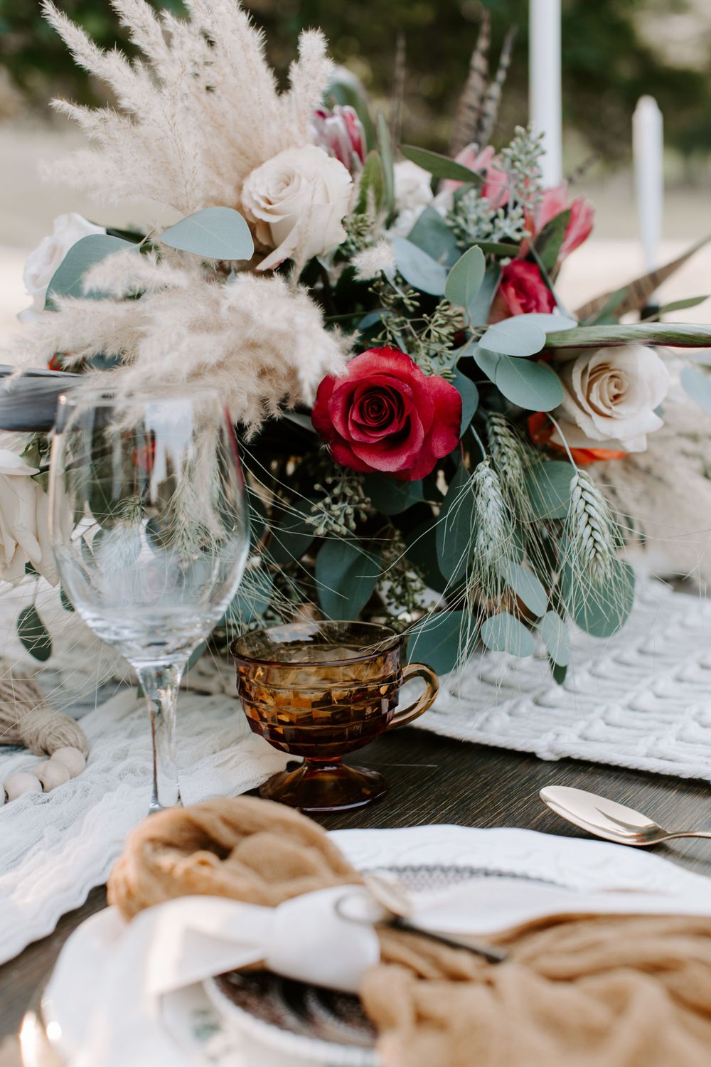 the bride and grooms wedding table with red and white flowers