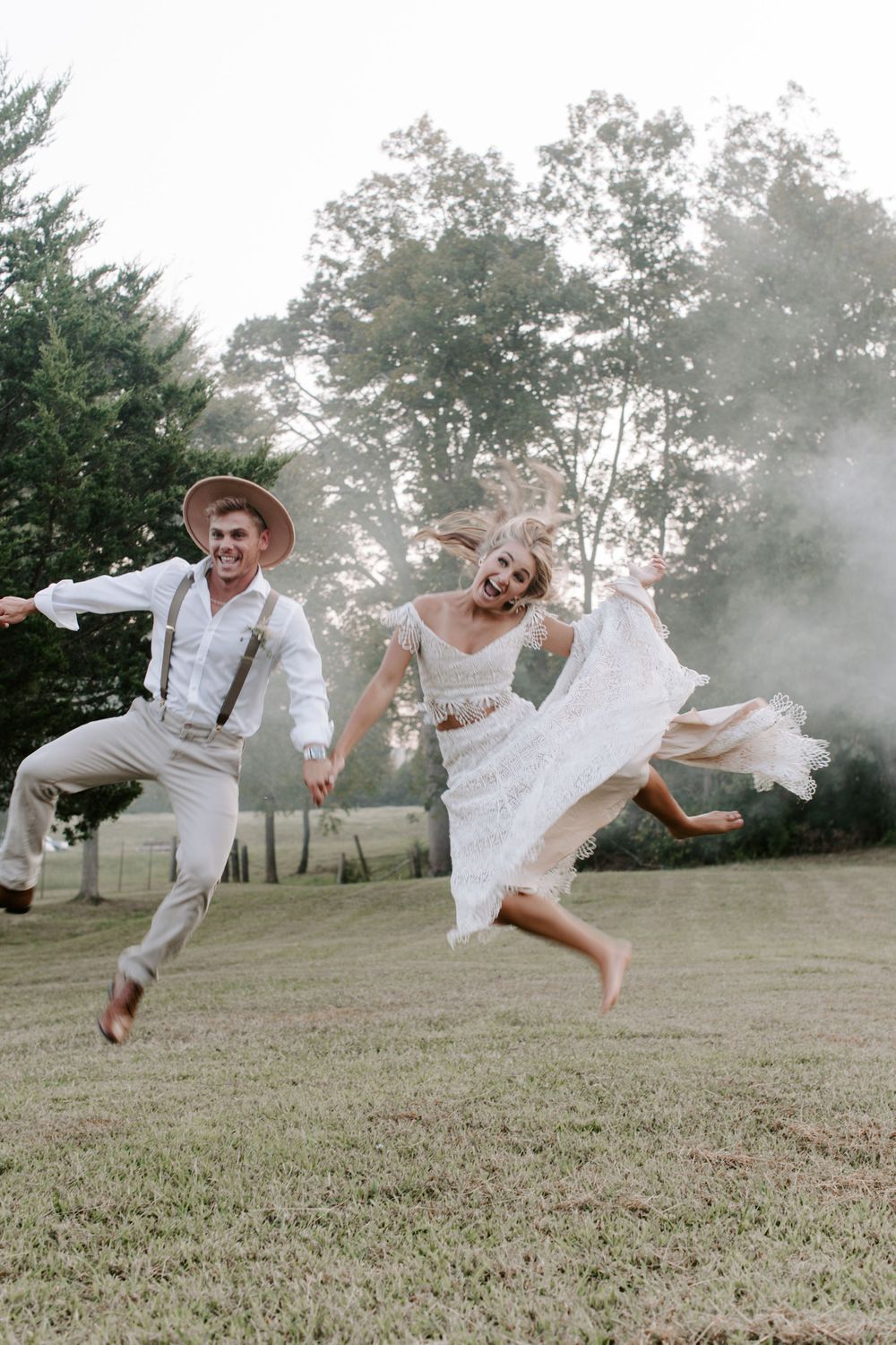 couple jumping in the air making silly faces during their Tennessee sunset elopement