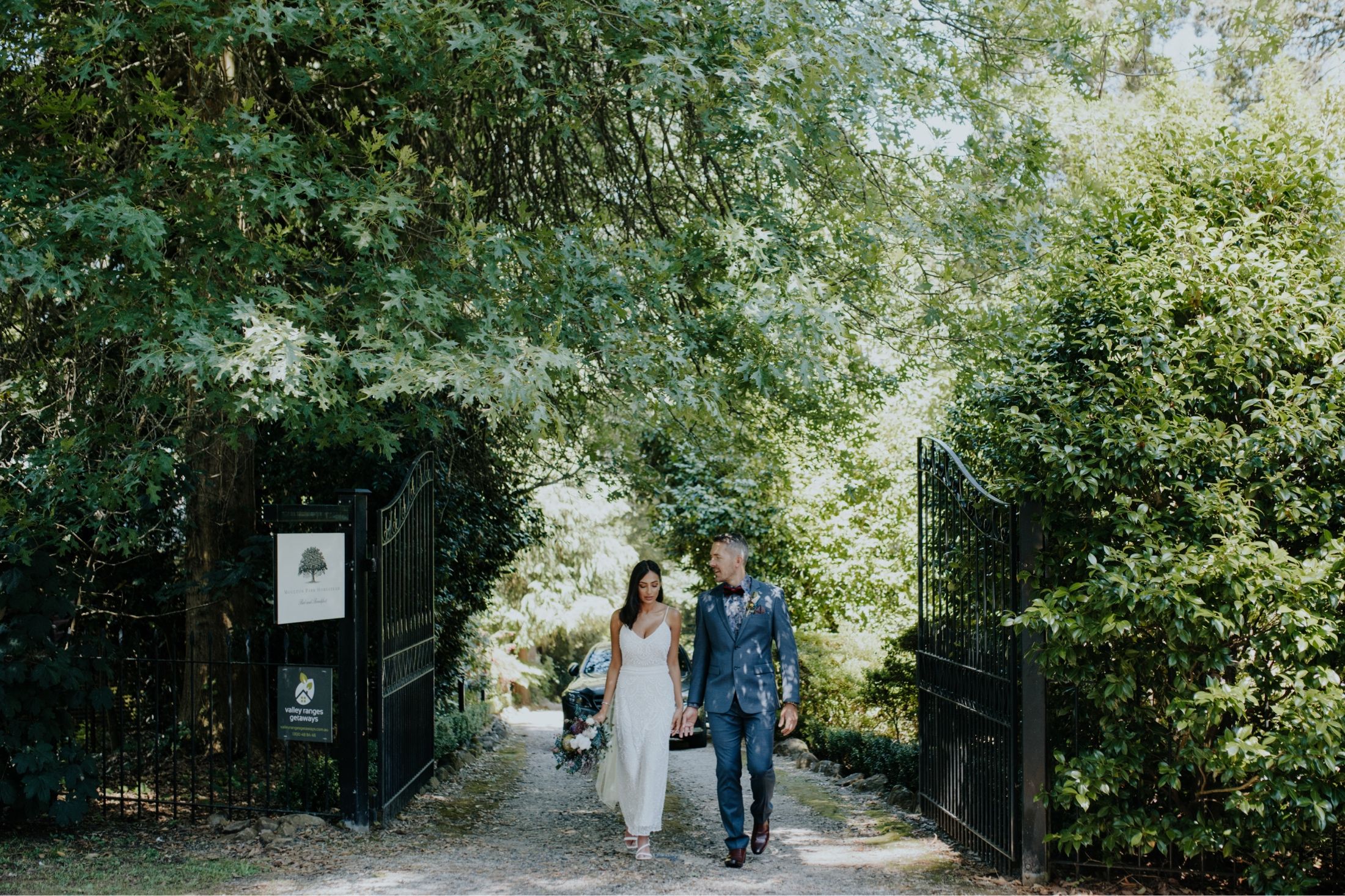 Bride and groom at entrance of Moulton Park Estate