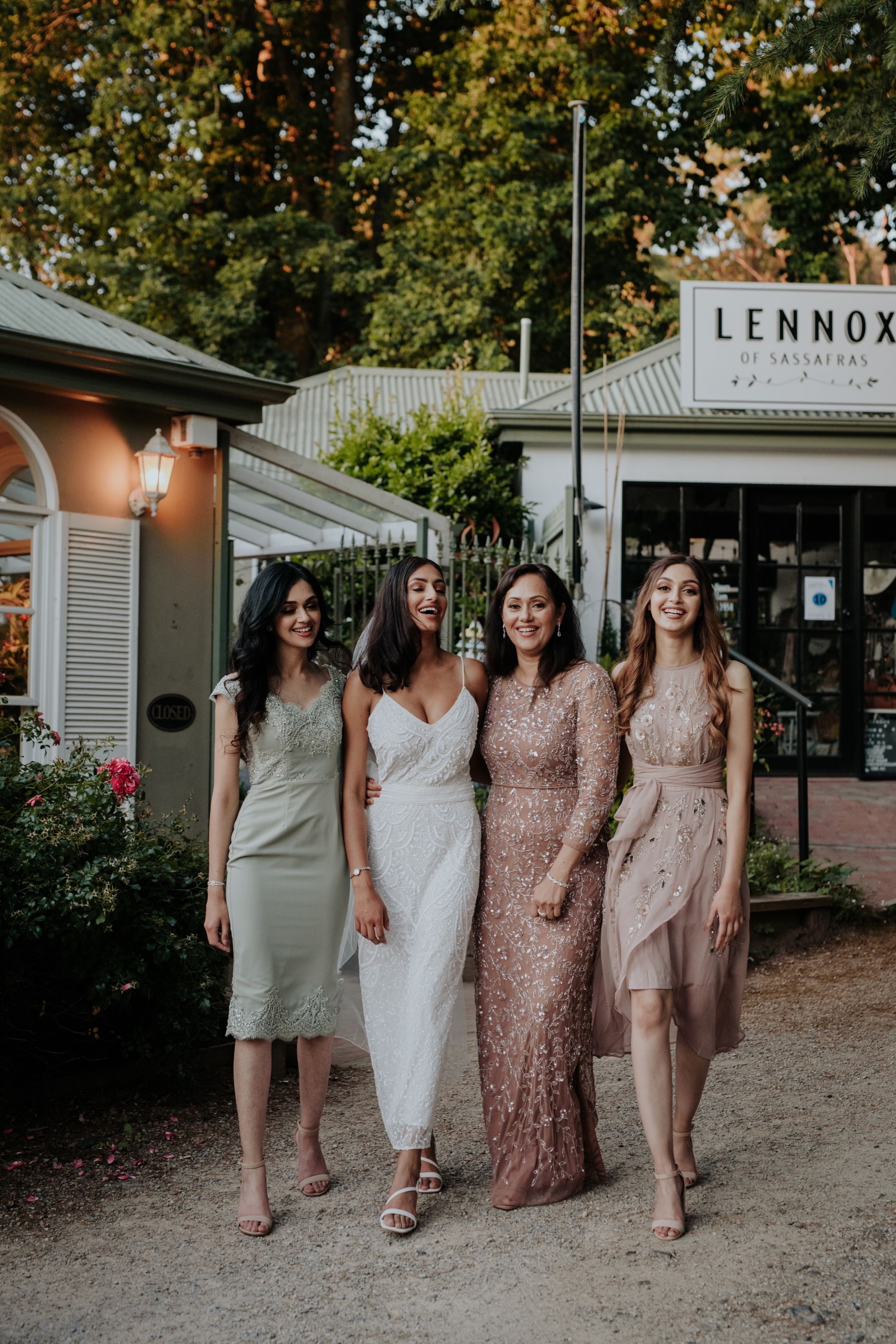 beautiful Pakistani bride in 1920s bridal gown with sisters and mum outside Fortnums Sassafras