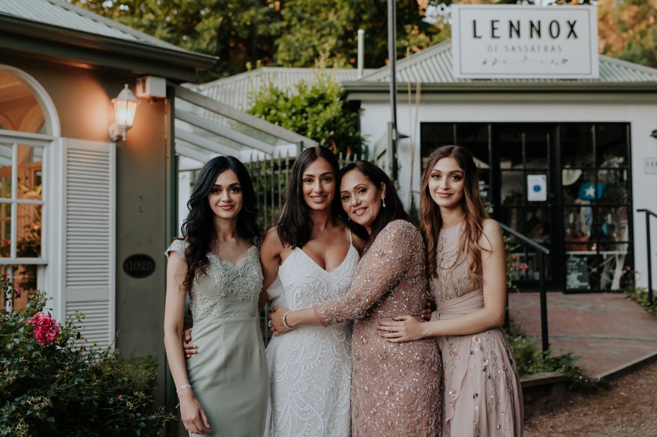 beautiful Pakistani bride in 1920s bridal gown with sisters and mum outside Fortnums Sassafras