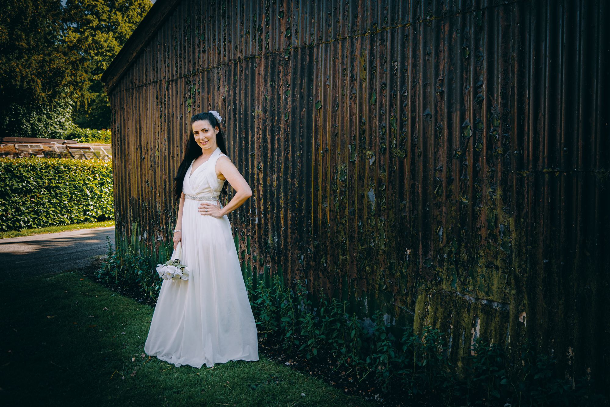 Bride against an iron shed