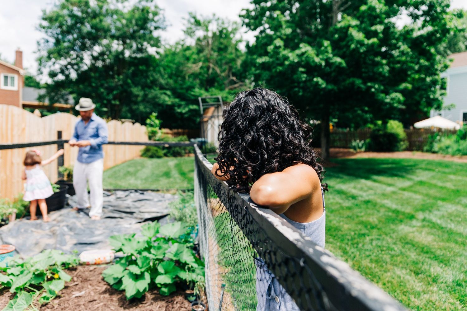 Family checking on their backyard garden in Charlotte, NC
