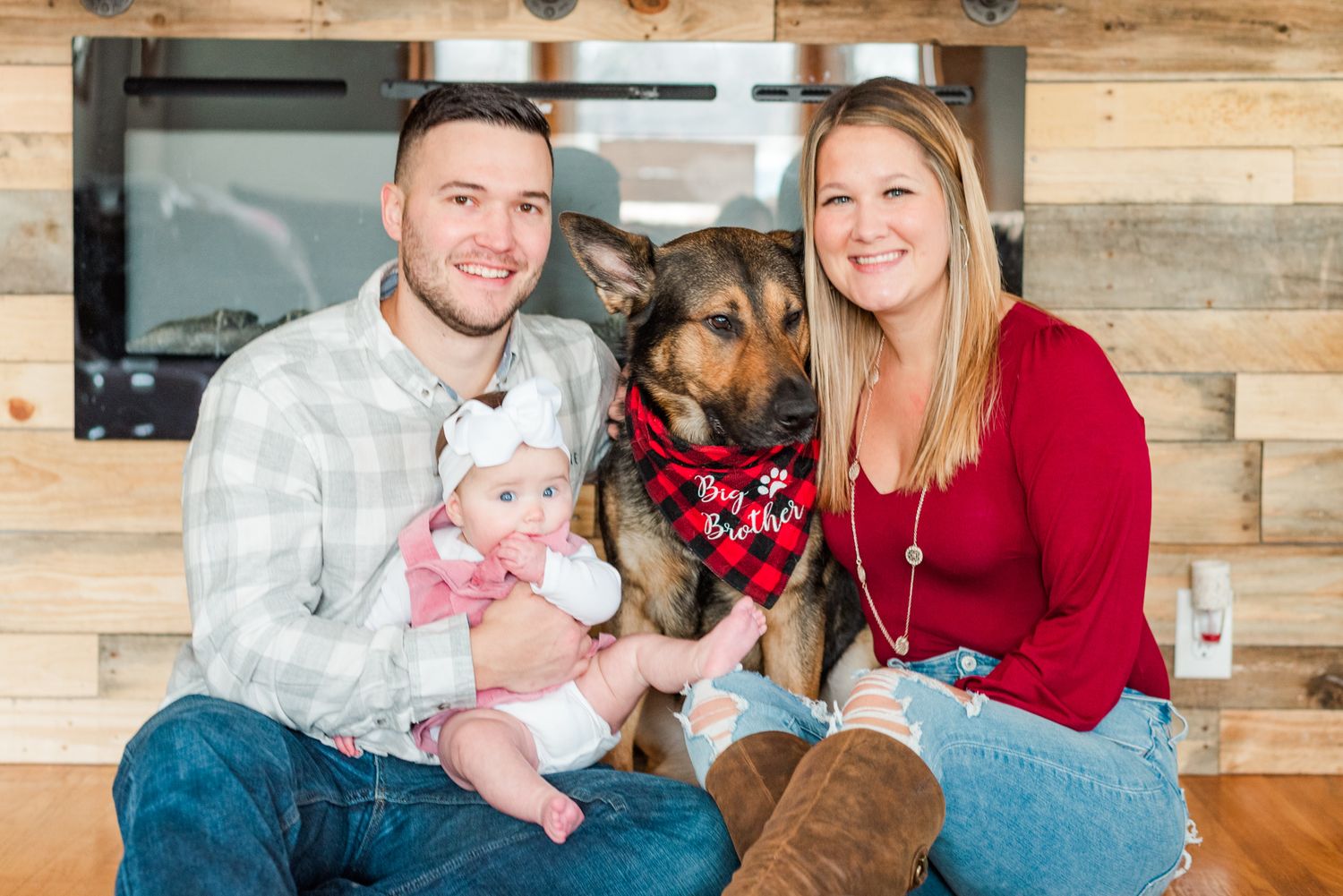 Lifestyle family photoshoot in the home with mom, dad, dog, and 6 month old baby wearing bow in Gibsonia, Pennsylvania