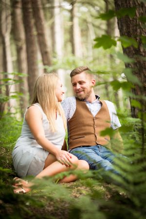 Couple smiling during engagement photoshoot in Formby beach woodland