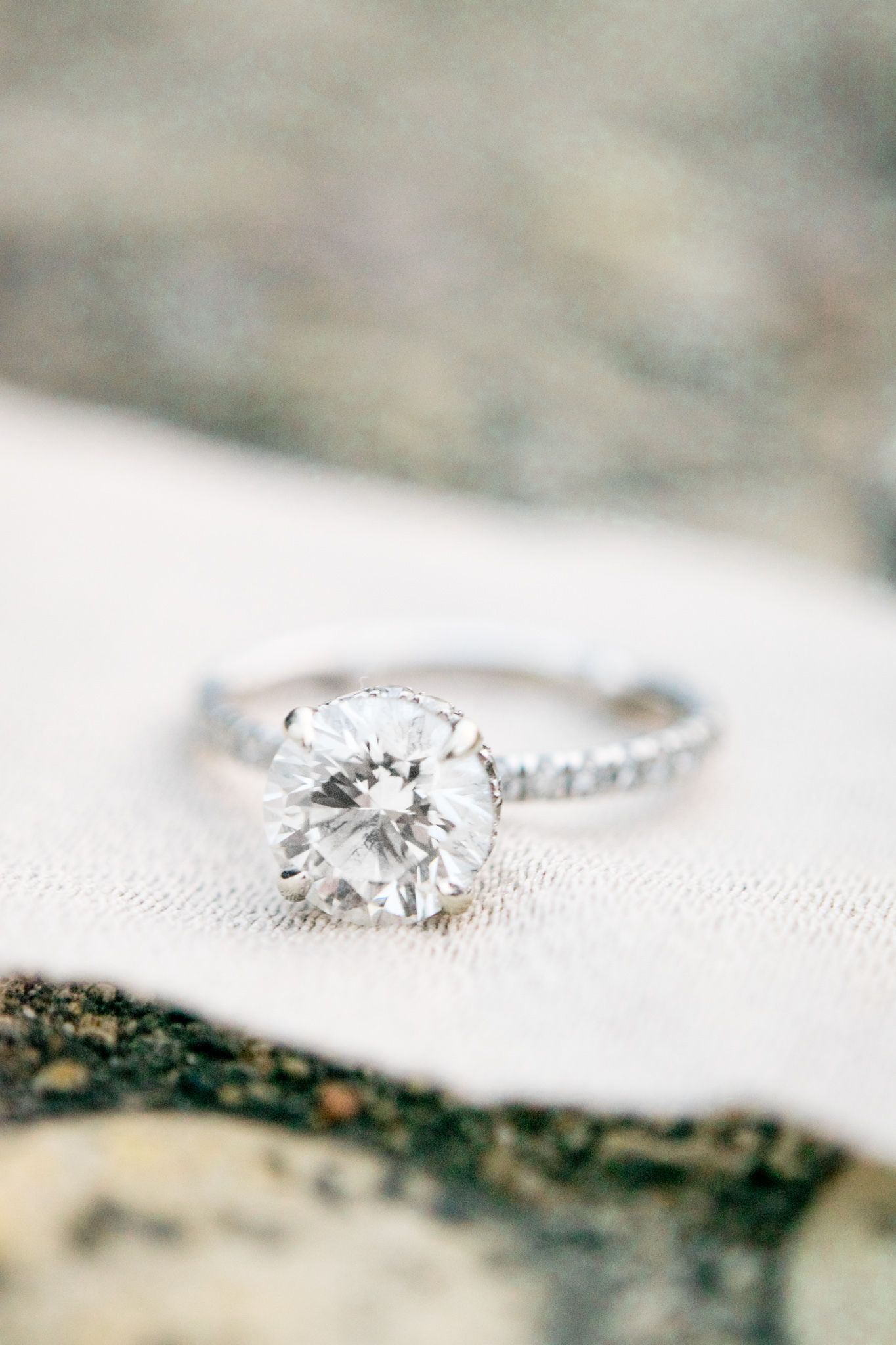 round diamond engagement ring with white gold on a ribbon