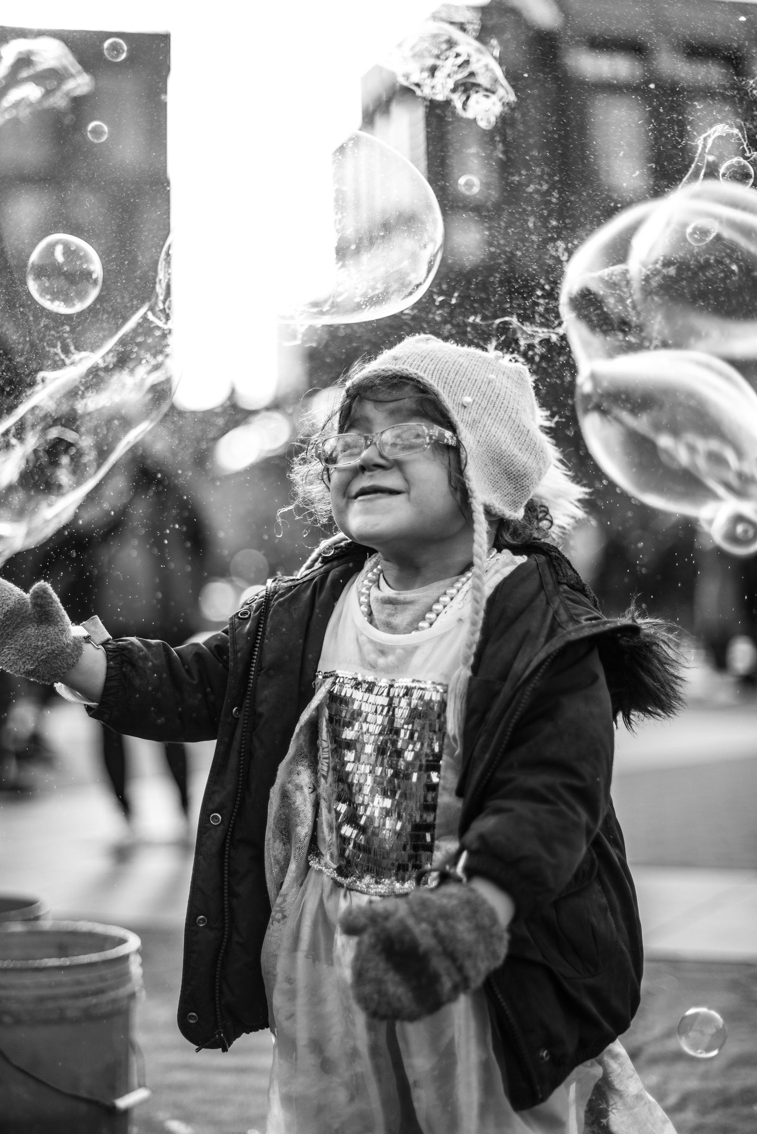 Little girl playing with bubbles in Washington Square Park, NYC