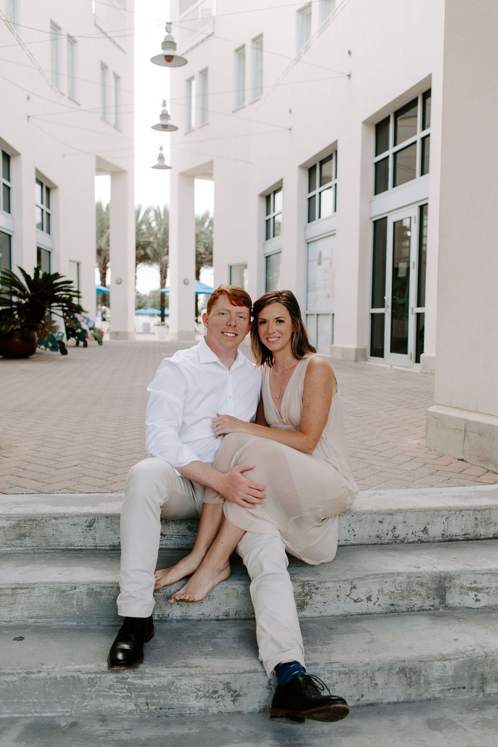 couple sitting down together in Seaside Florida after their beach elopement