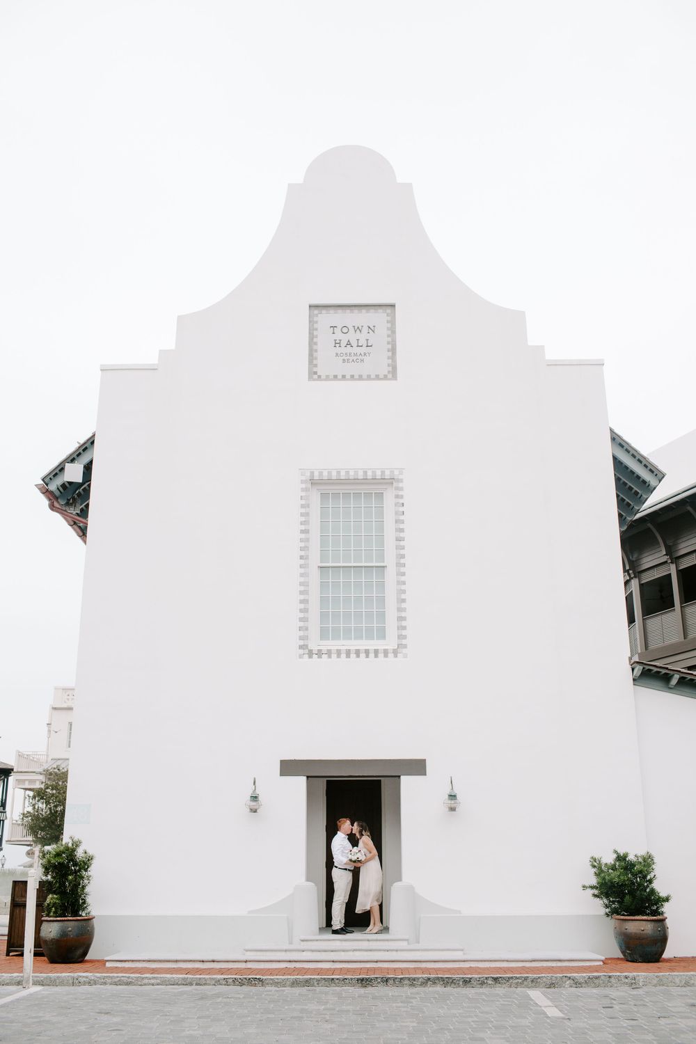 couple standing in a doorway in Rosemary Beach during their Florida Beach elopement