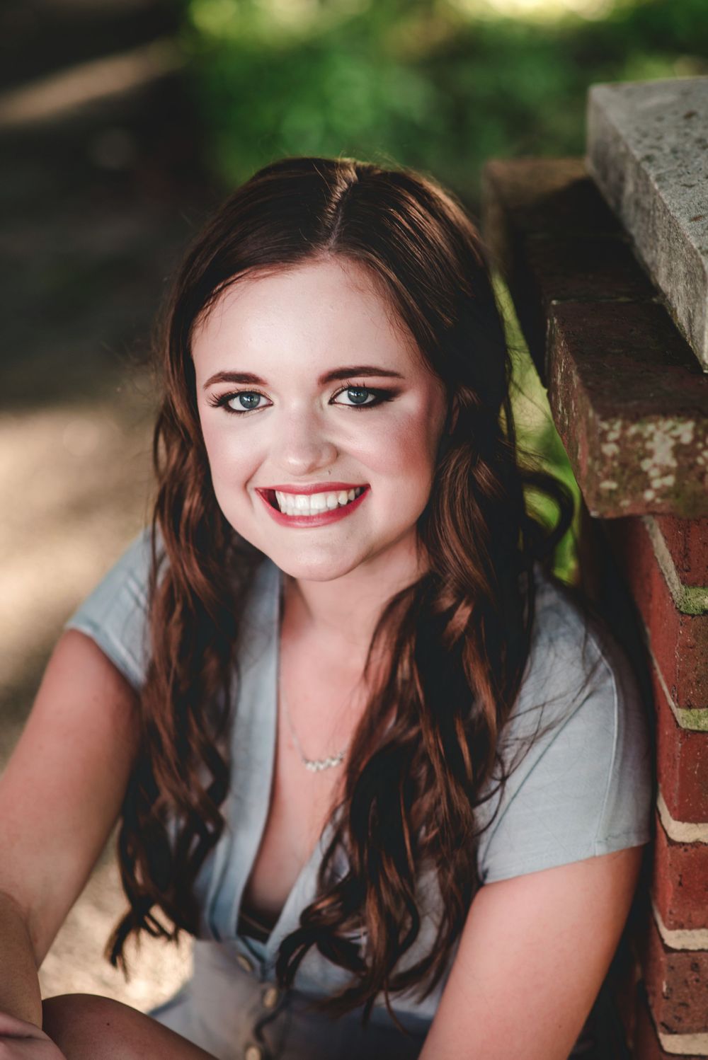 High School Senior Photo of a girl with long brown hair smiling