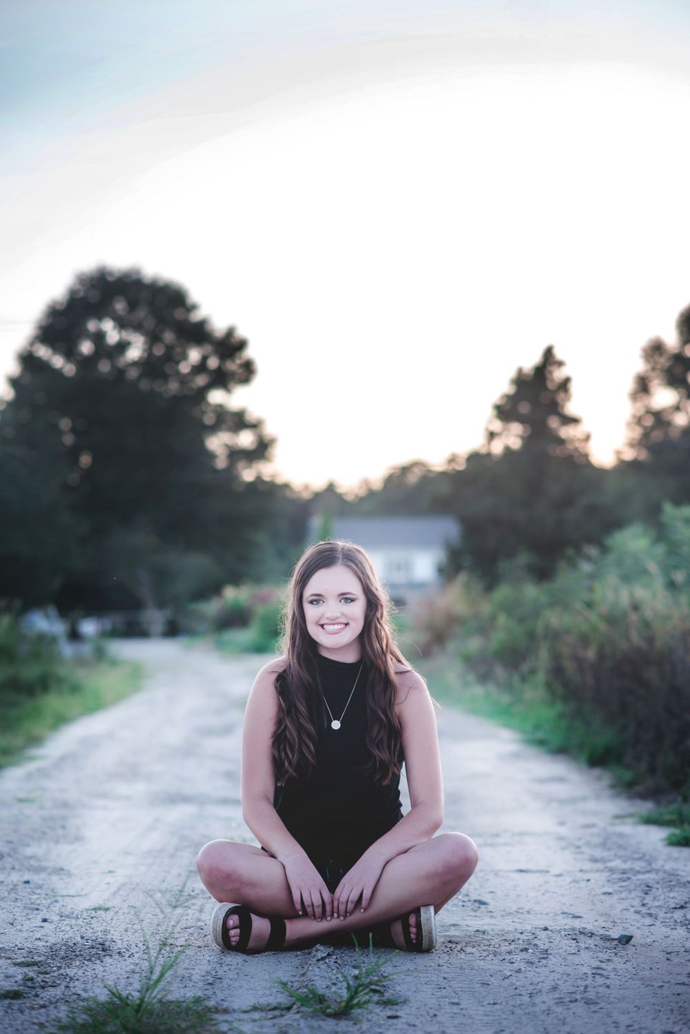 High School Senior Photo of a girl sitting on a gravel lane