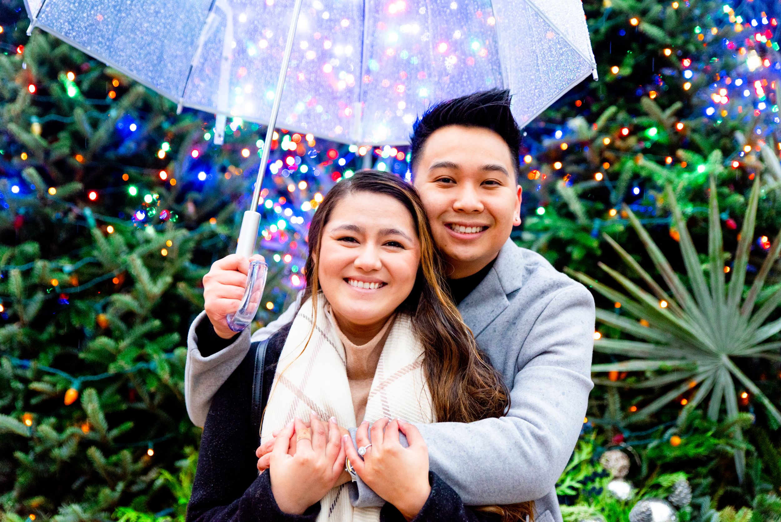 couple hugging under umbrella on rainy day in Chicago Millennium Park
