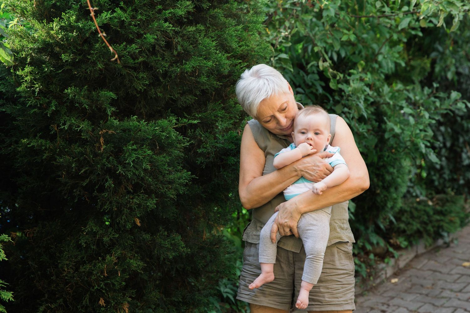grandma holding 6 month old baby girl in arms