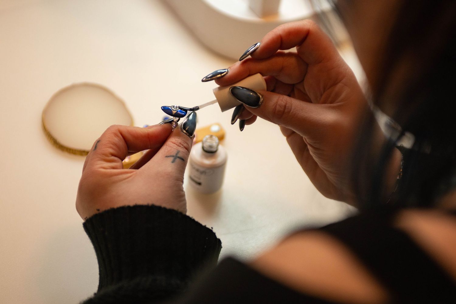 Kayla of KRAESTUDIO in ERIE PA working on set of custom nails for a client while I captured her in action.