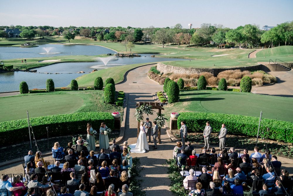 Overhead perspective of an outdoor ceremony of a bride wearing a Robert Bullock gown at Stone Briar Country Club