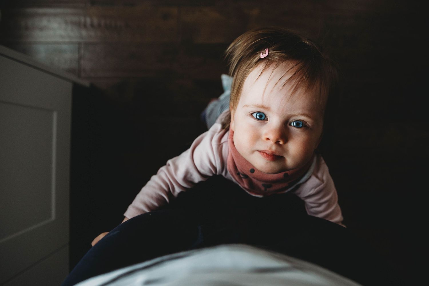 toddler girl looking up at camera blue eyes