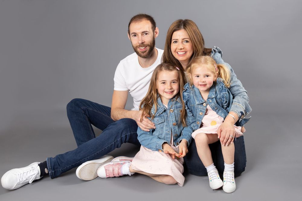 family with mum dad and 2 little girls in denim jackets