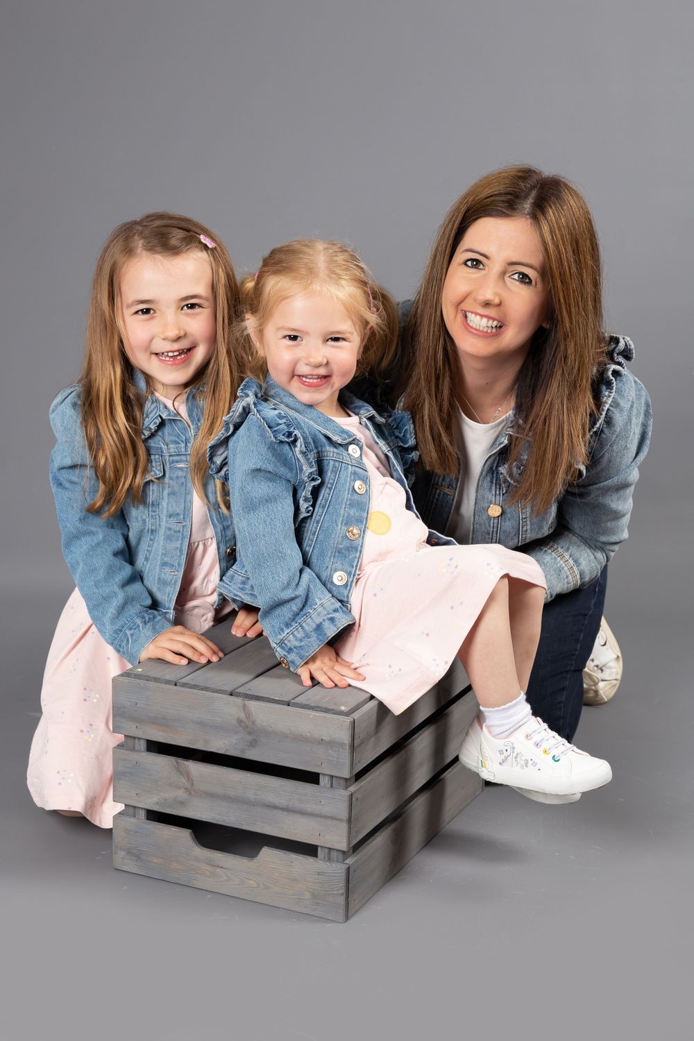 mum with two little girls in denim jackets