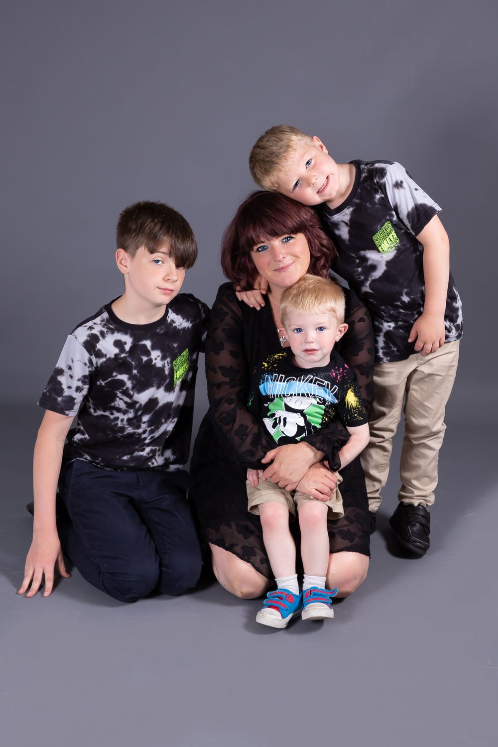 mum sat on the floor with her 3 sons