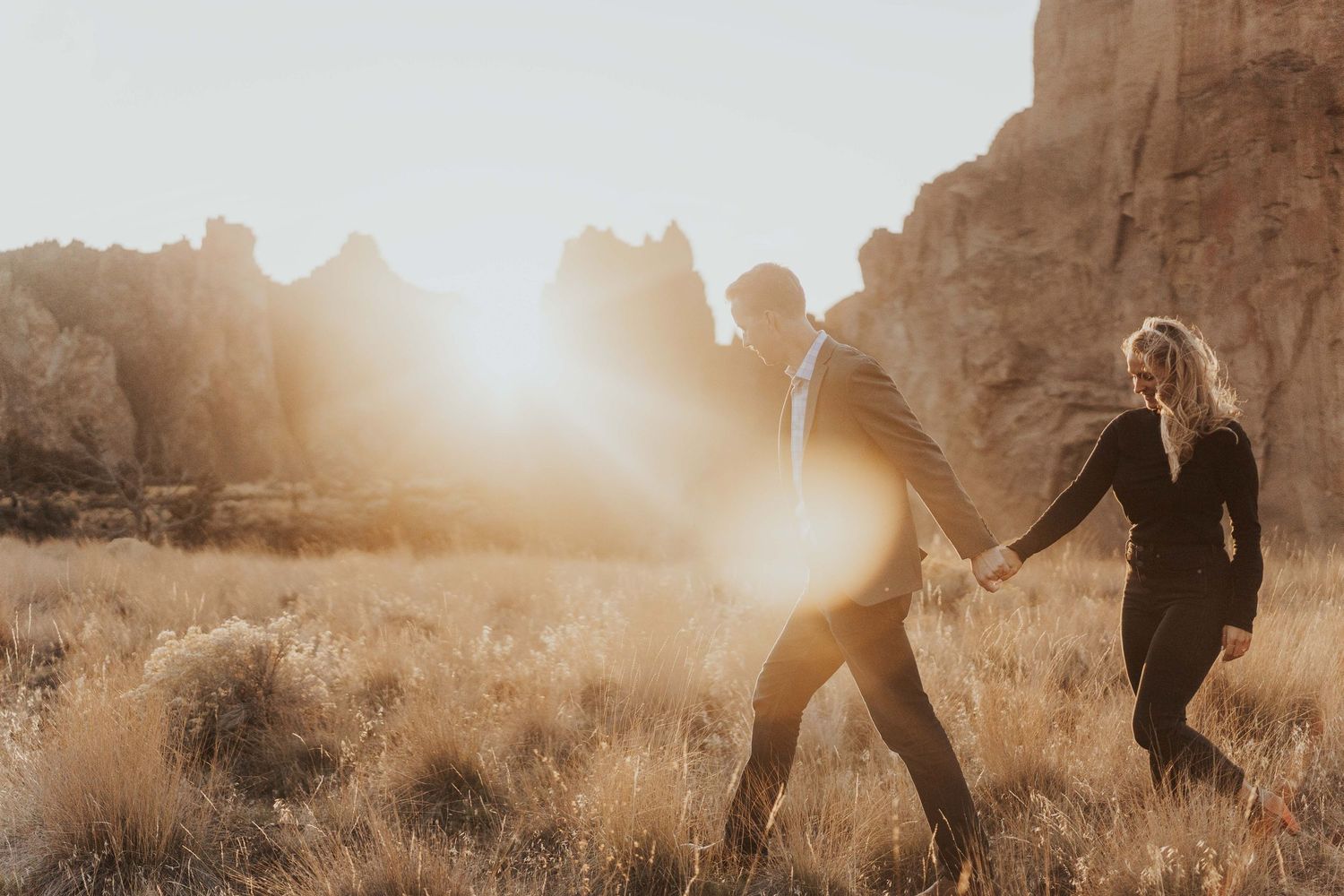 Photo by Kelsie Burke Photography of the couple walking hand in hand through Smith Rock State Park