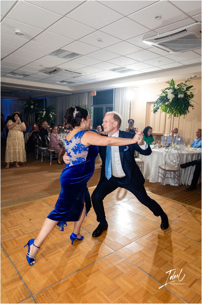 Energetic dance moves on the wedding reception dance floor.