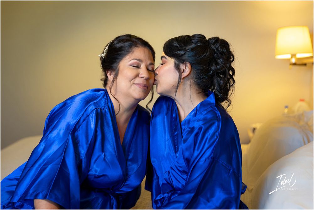 Two people in bright blue robes sharing an affectionate moment.
