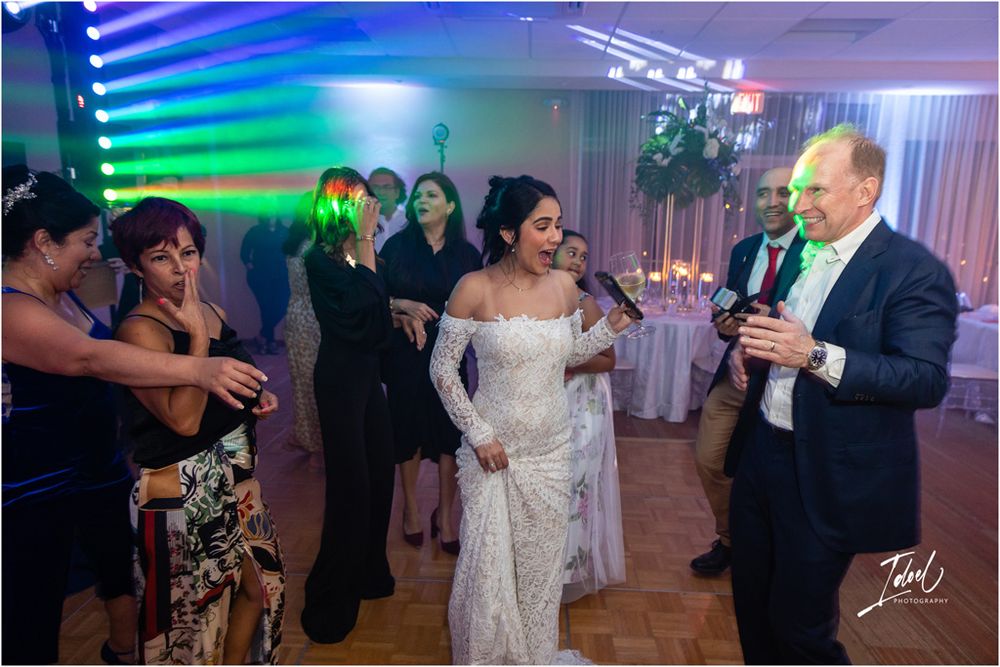 Wedding reception dance party with colorful lighting effects.