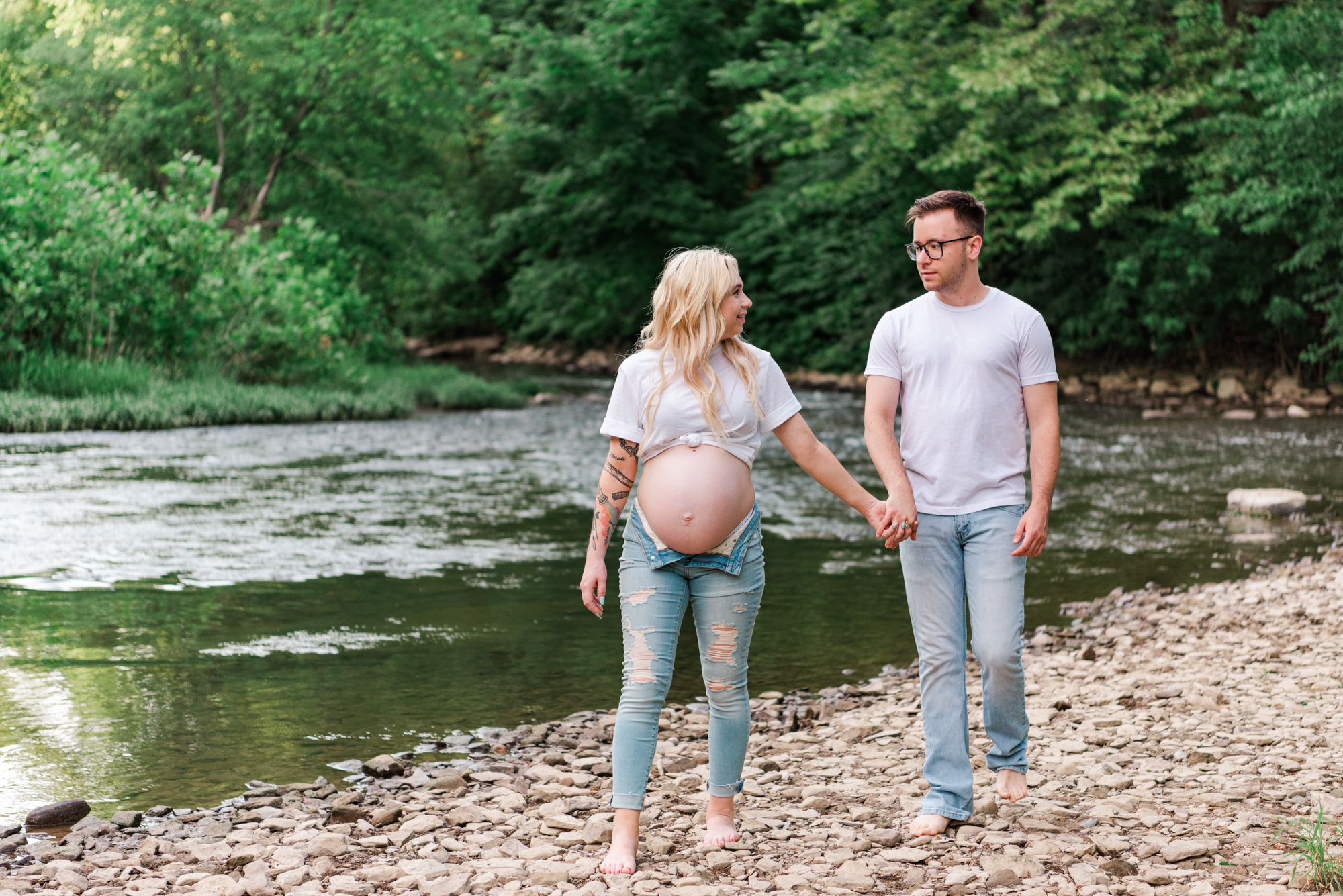 Casual maternity photos in jeans and white shirt in stream in Zelienople, Pennsylvania