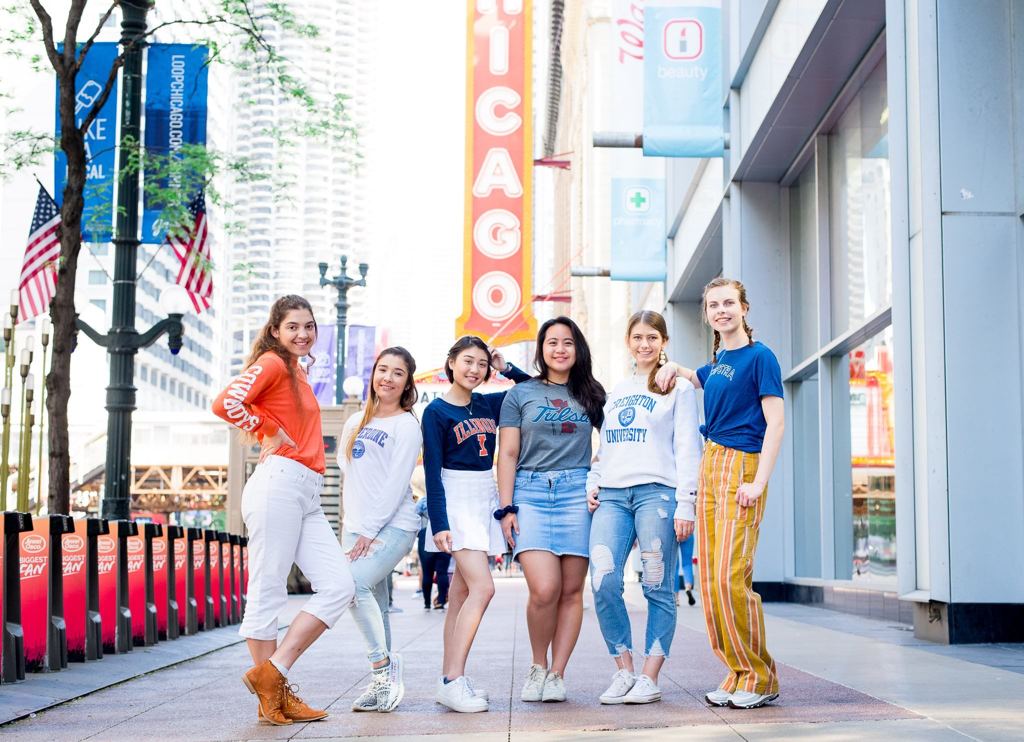 six senior girls in front of the Chicago Theater sign for Chicago senior pictures