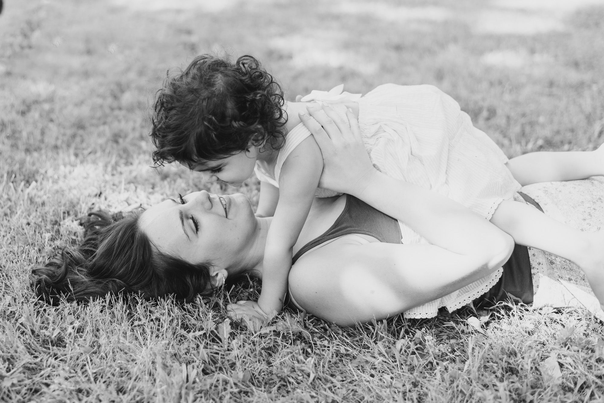 Mom and daughter laying in grass in black and white at Emmerling Park in Cheswick Pennsylvania