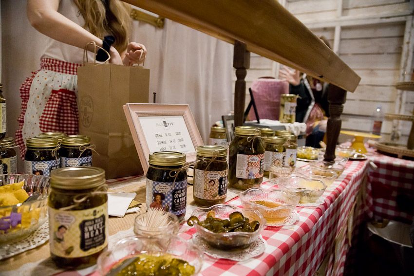 Pinology Puyallup Pickles and Pie Booth Owner bagging customer purchase