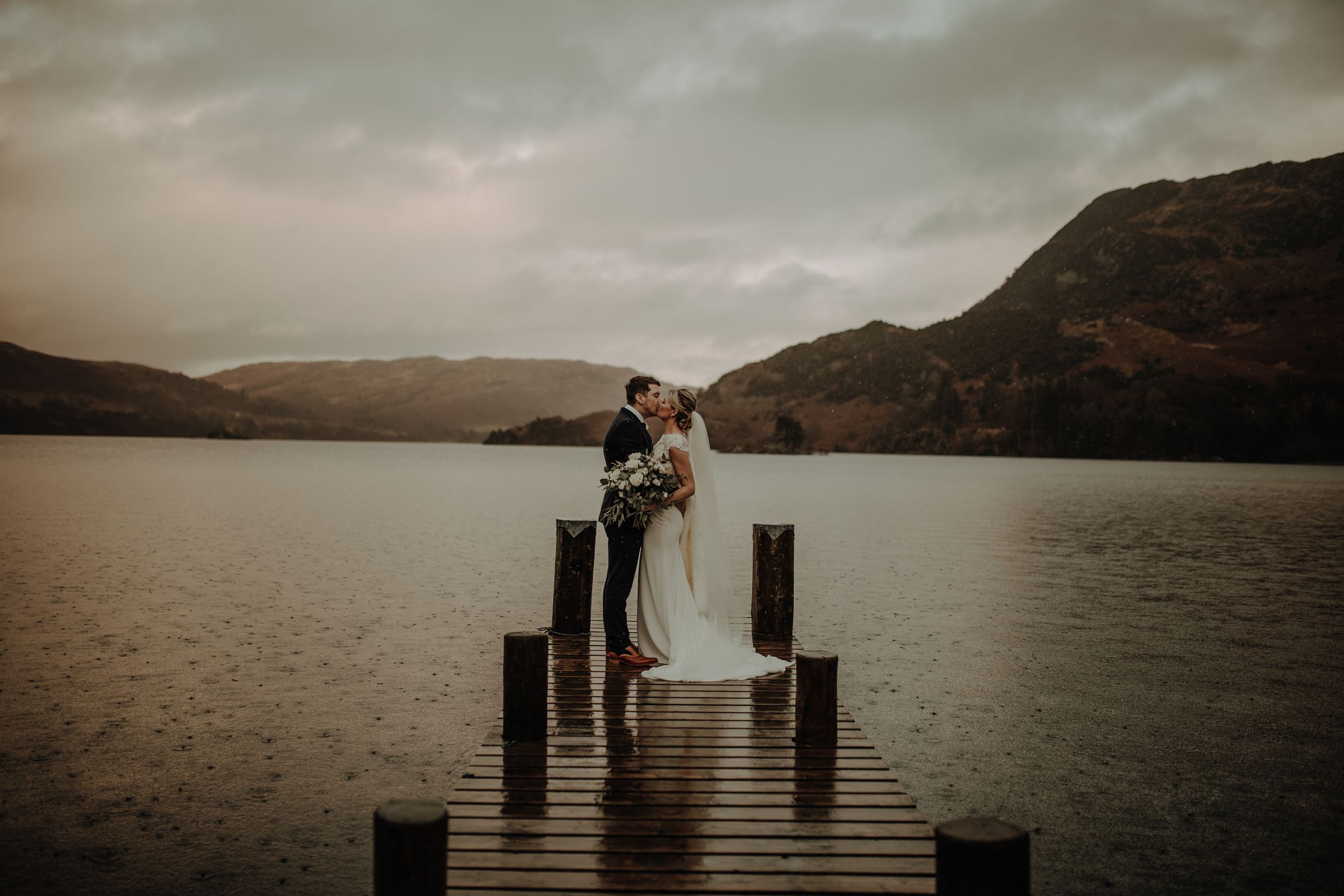 Lake District Wedding at Inn on the Lake. Bride and groom on jetty. Lake district wedding photographer. Winter wedding