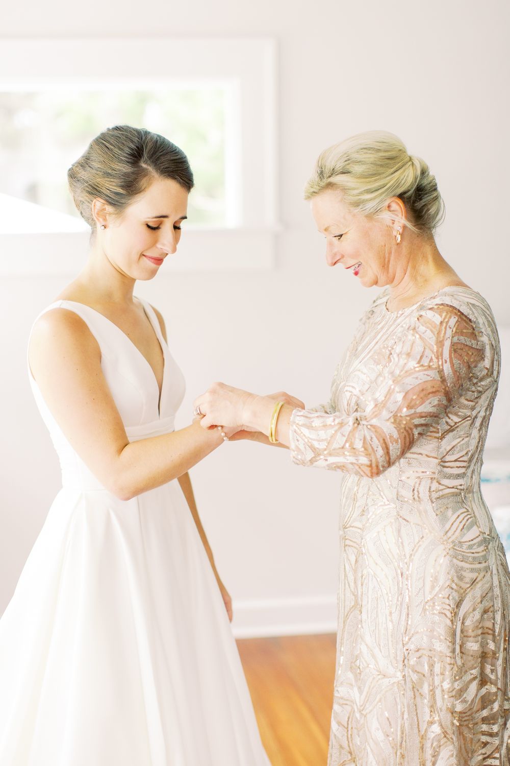 bride and mother share a moment while getting ready for wedding day in wilmington island home
