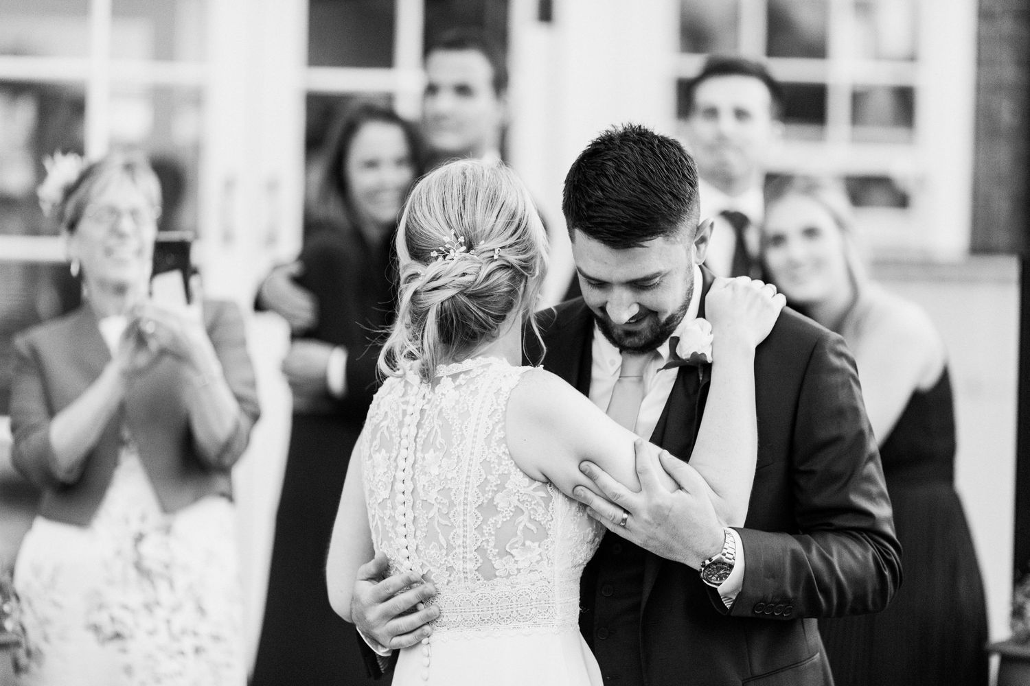 happy couple dance in front of family