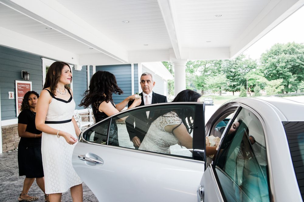 Friends help Hudson Valley bride exit car to ceremony