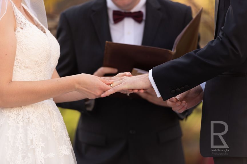 Leah Ramuglia Photography bride puts wedding ring band on husband small micro ceremony at home