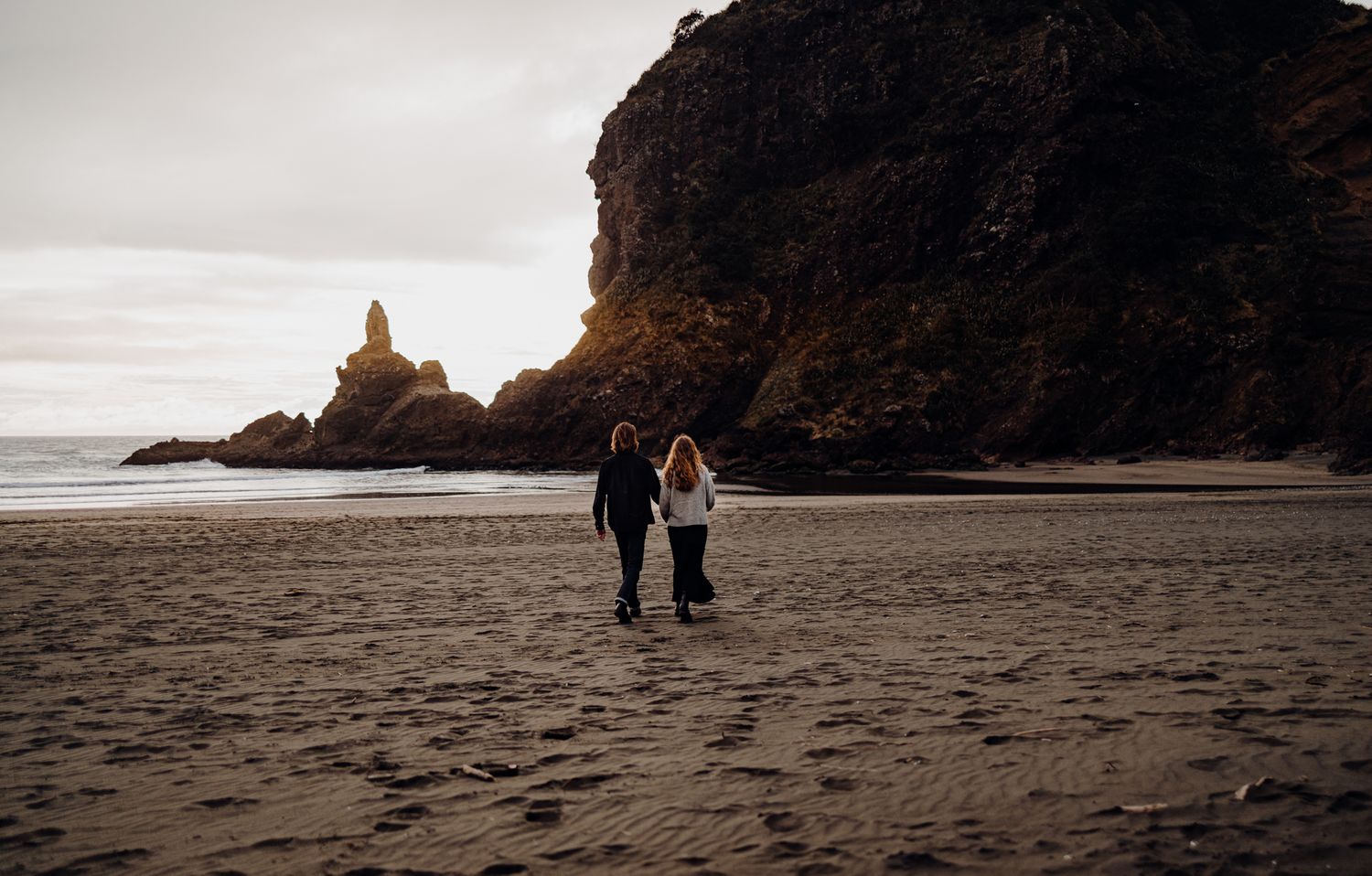 A couple in Piha Beach for their engagement session with Apertured Media-Auckland Wedding and Elopement Photographer