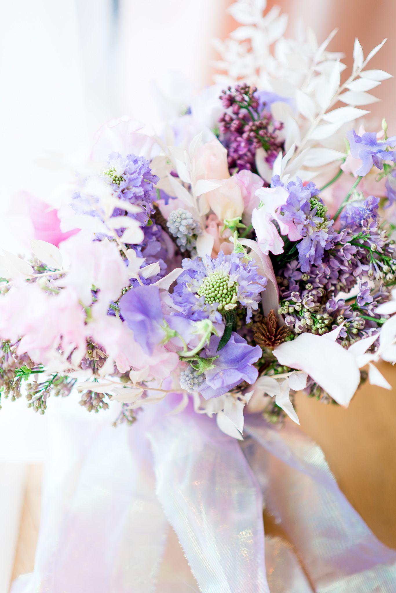 colorful wedding bouquet with purple lilacs and pink sweet pea flowers for a spring wedding bouquet