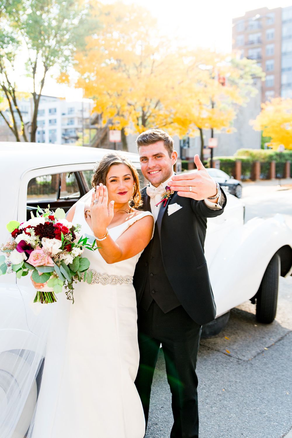 bride and groom show off their rings after fall chicago wedding wedding ceremony