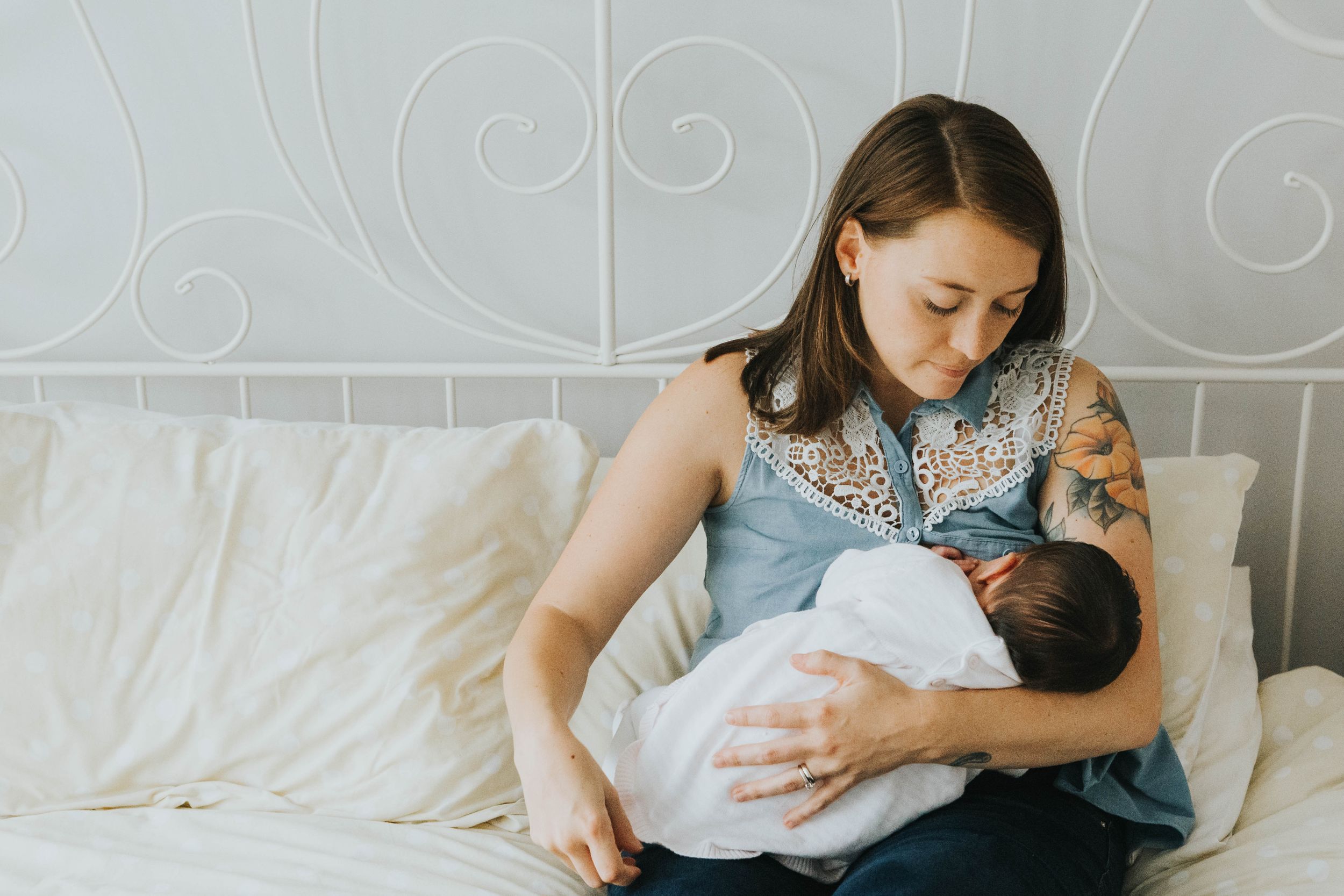 tattooed mum breastfeeding baby daughter