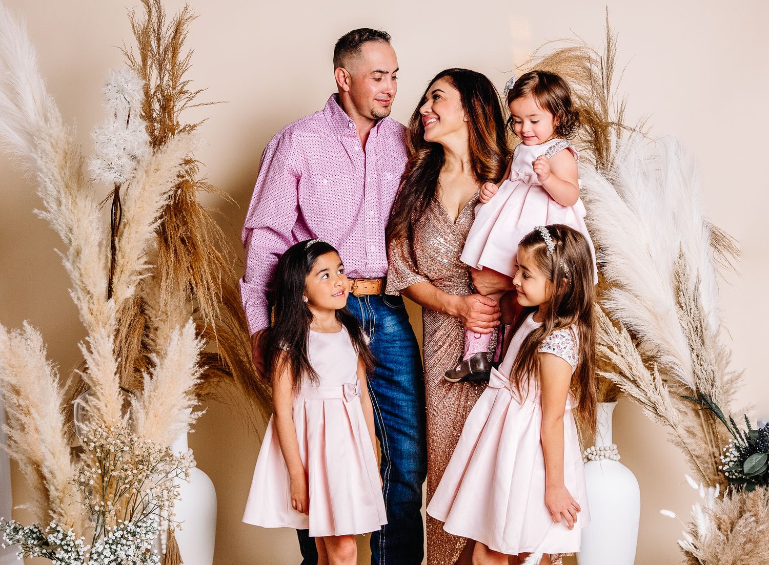 indoor studio family of 5 posing for a mothers day photoshoot.